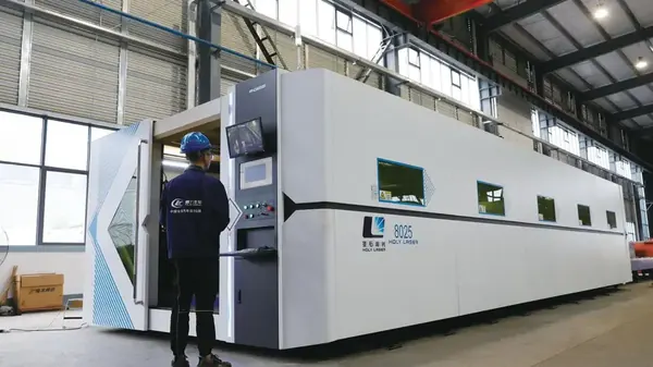 Operator running CNC laser cutting machine for truck body steel at CLW workshop